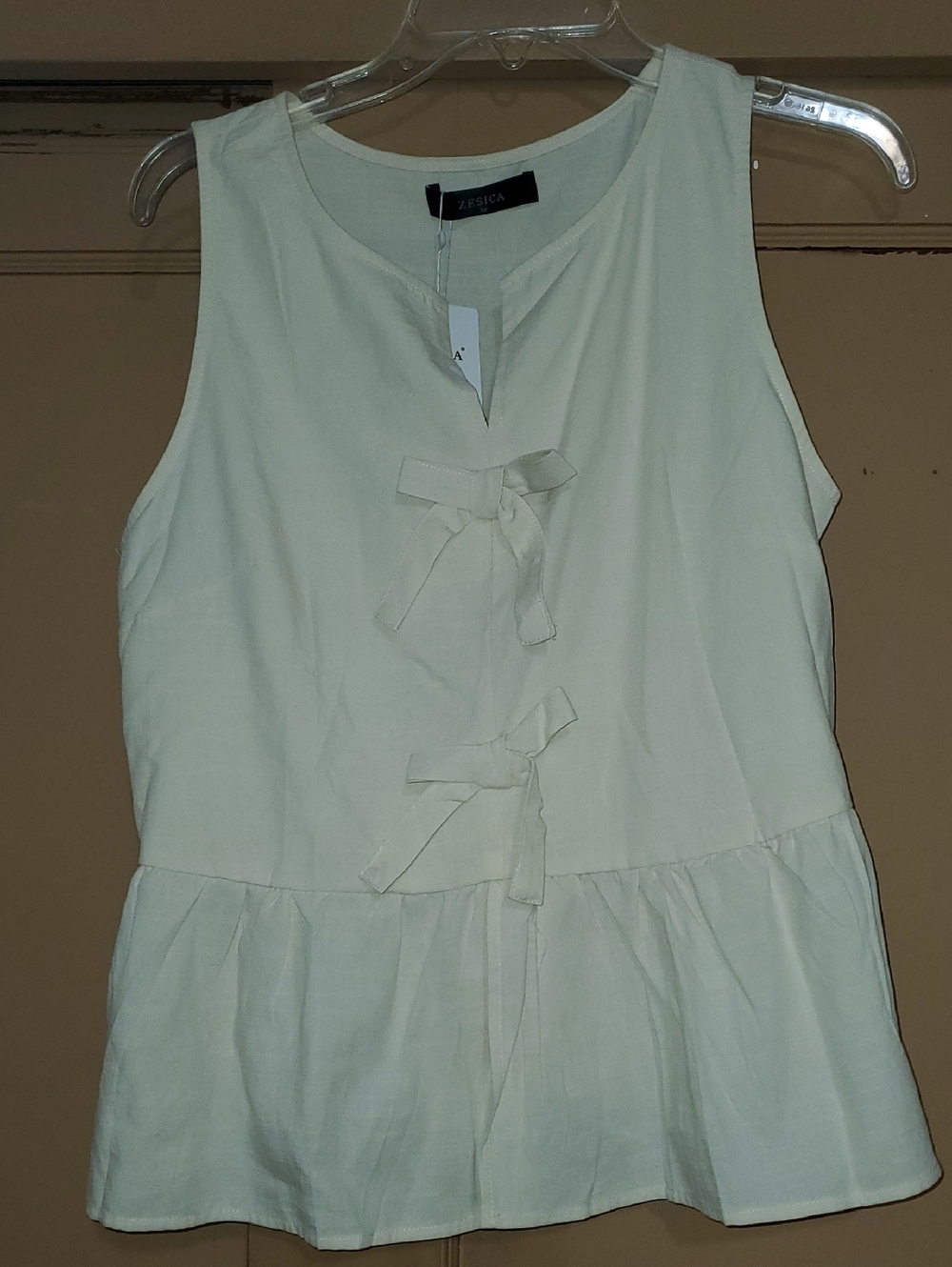 Sleeveless Cream Bow Peplum Tank Top by Zesica